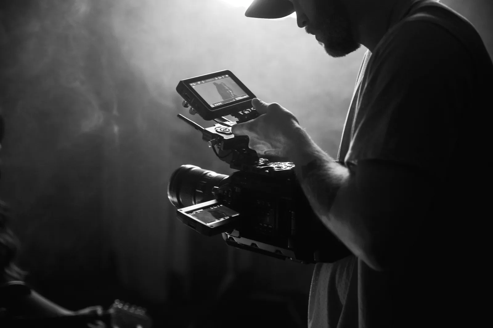 A camera held up in low light, the lens catching a highlight