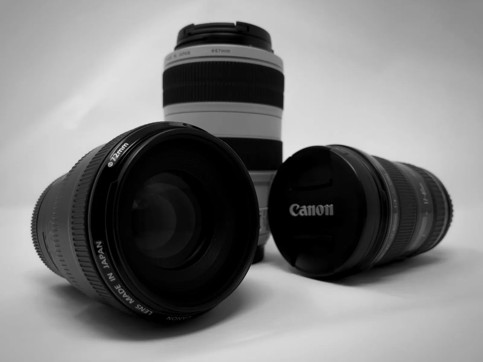 A camera lens and its hood on a table