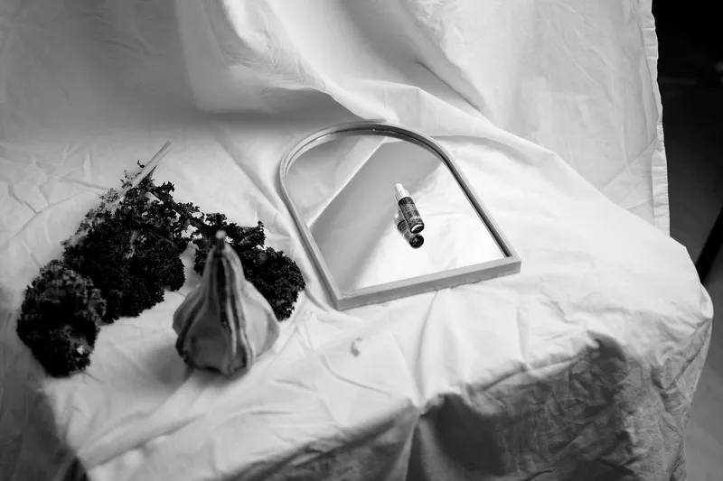 A still life of fruit and glass on white cloth