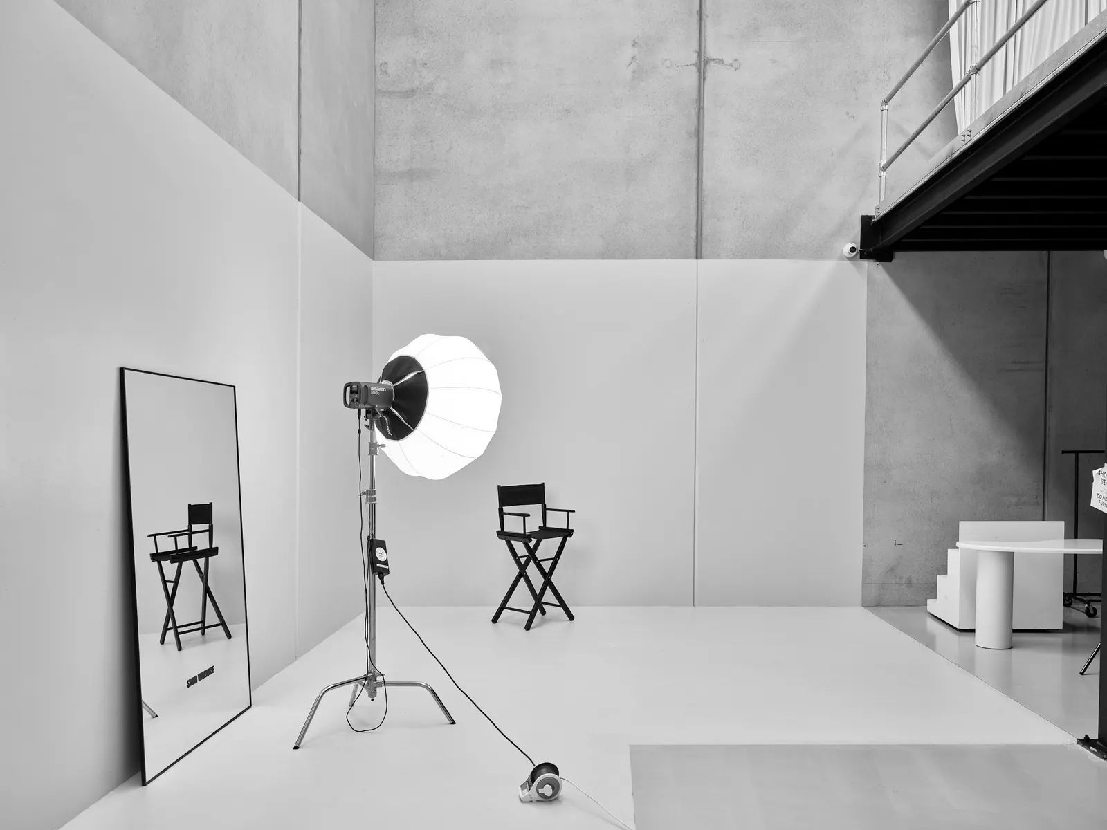 A white studio cove with a single round lantern light