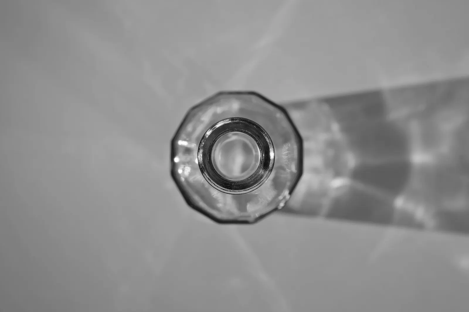 A cut glass photographed from above with light passing through it