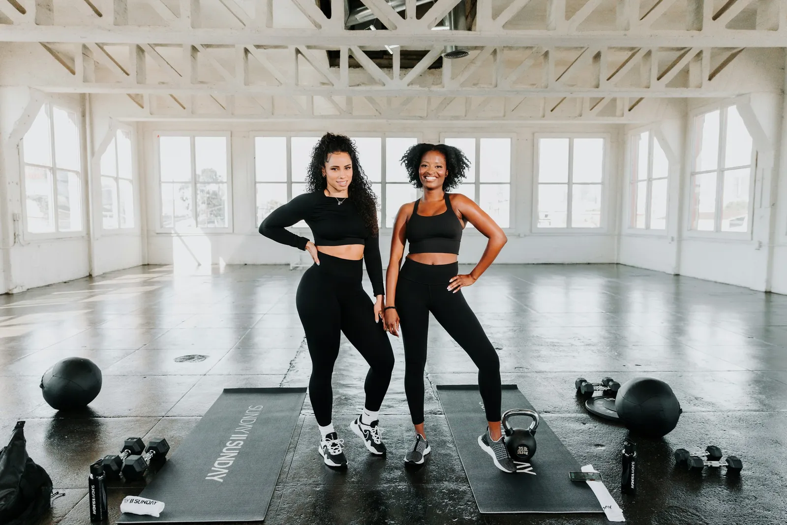 Two members laughing together in the gym