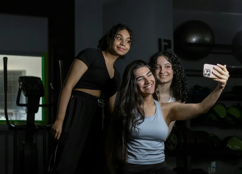 Three friends taking a selfie after class
