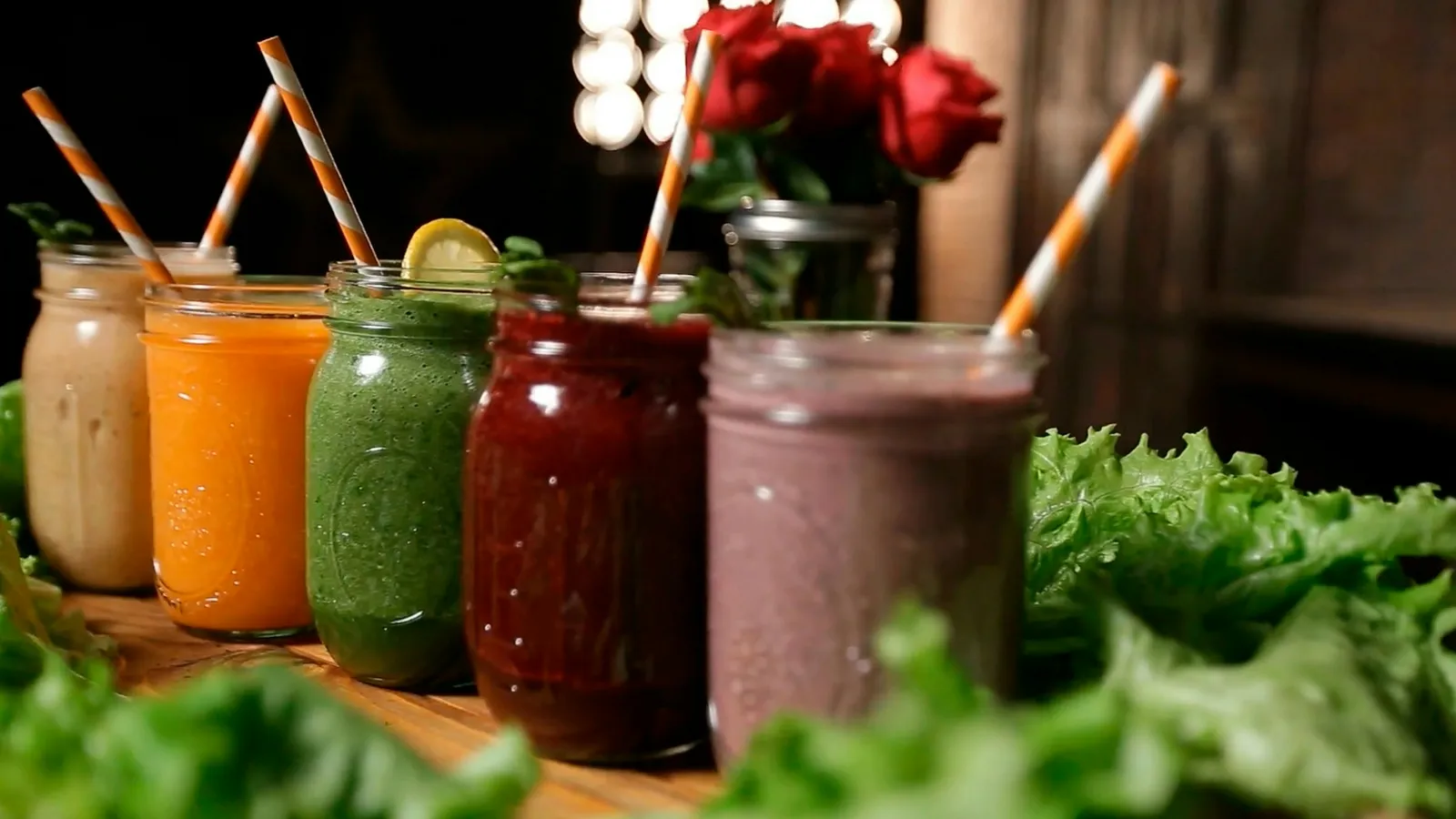 Jars of colourful fresh smoothies on a counter