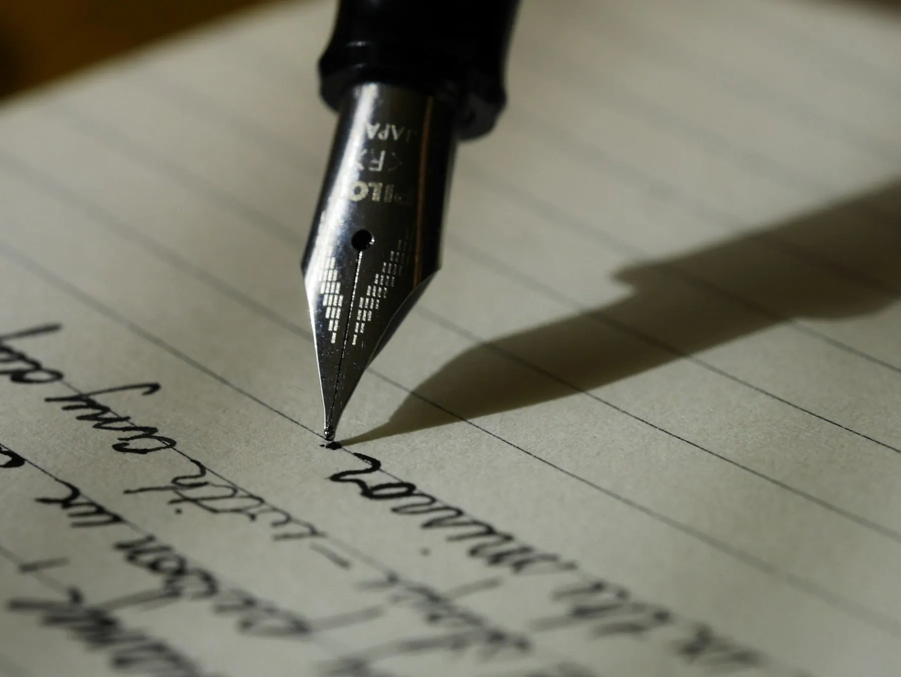 Fountain pen nib resting on paper