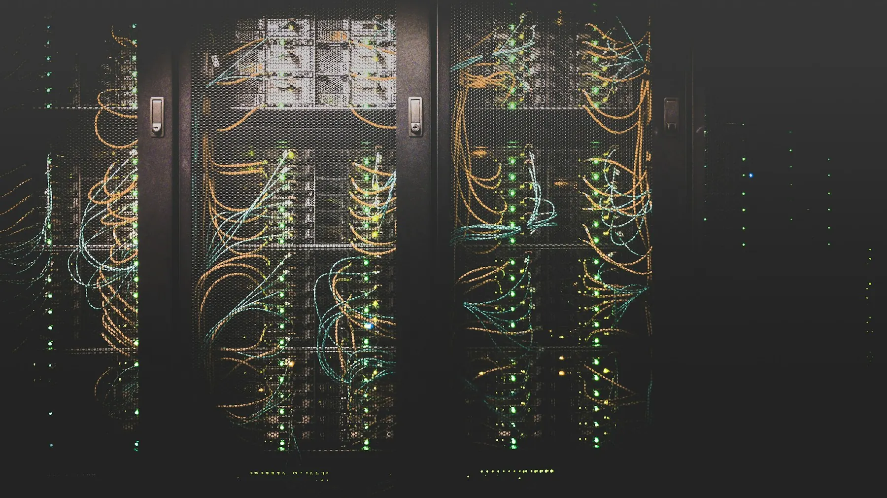 Rows of server racks lit in cool light