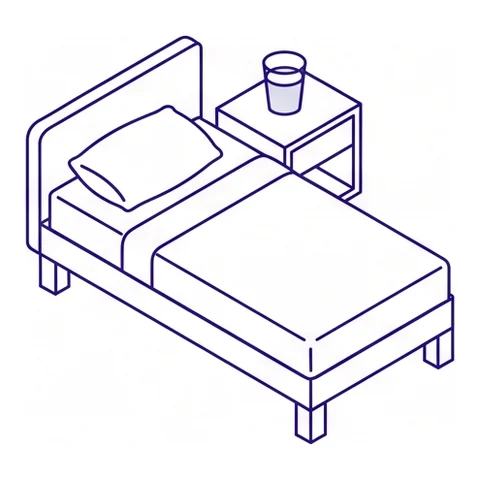 A recovery bed beside a side table with a glass of water
